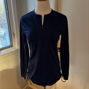Athleta Navy blue 1/2 zip pullover. Long sleeves, adjustable ruching on sides.